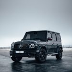 a black mercedes benz benz, G Wagon parked on a scenic overlook, luxury, durability, iconic design, bold lines, LED headlights, chrome accents, off-road capability, status symbol, professional photography, sunset backdrop.